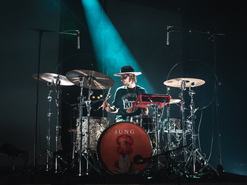 Drum set with drummer with cymbal baffles on stands